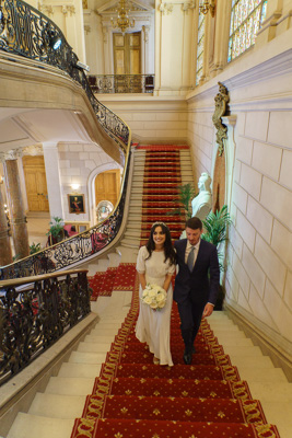 Photographe mariage Levallois - Les mariés montent les marches de la mairie