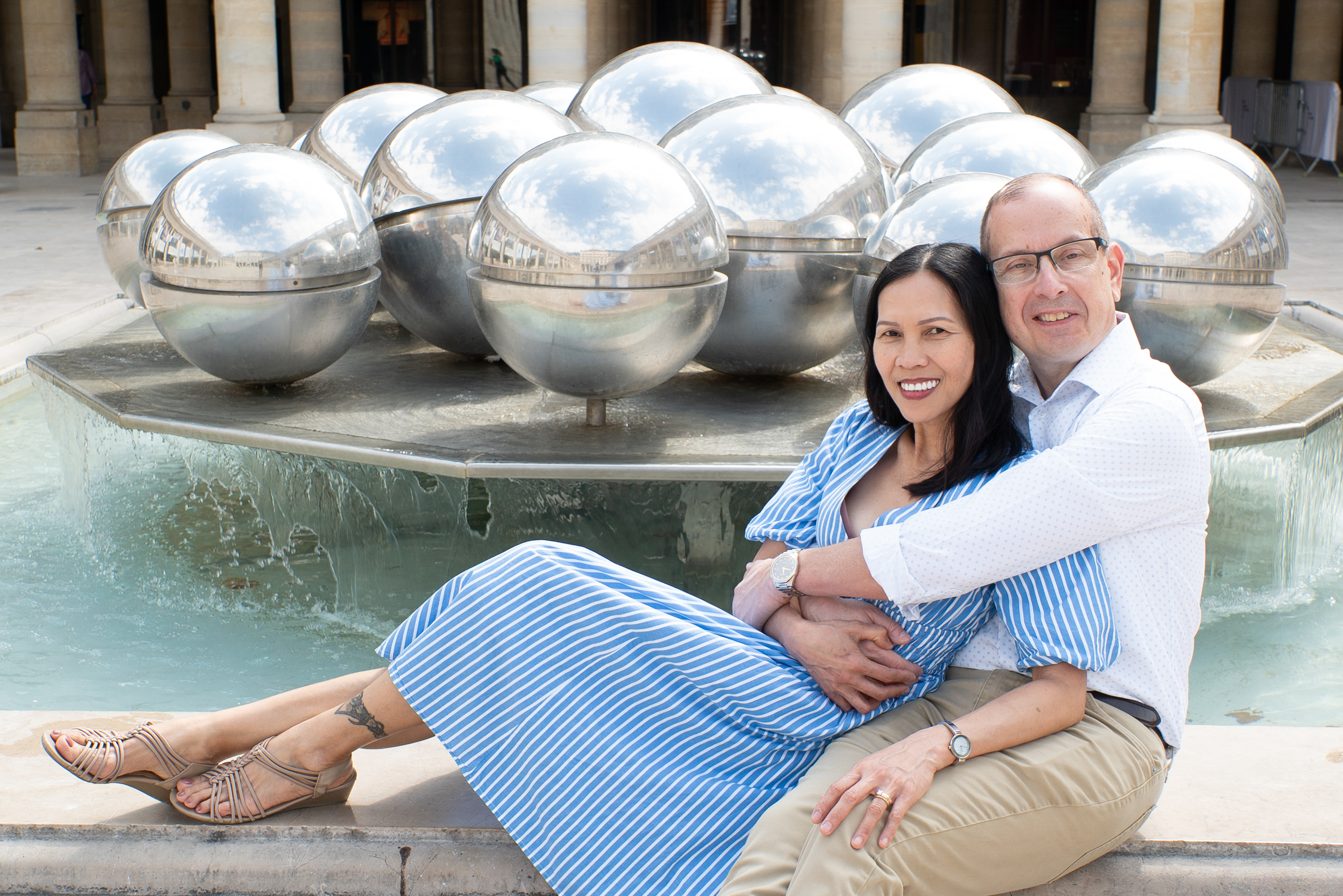Romantic couple Palais Royal fountain Paris — hidden garden near Louvre