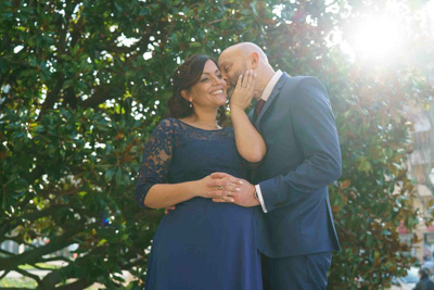 Portrait des mariés s'embrassant devant un arbre sur le parvis de la mairie de Boulogne-Billancourt