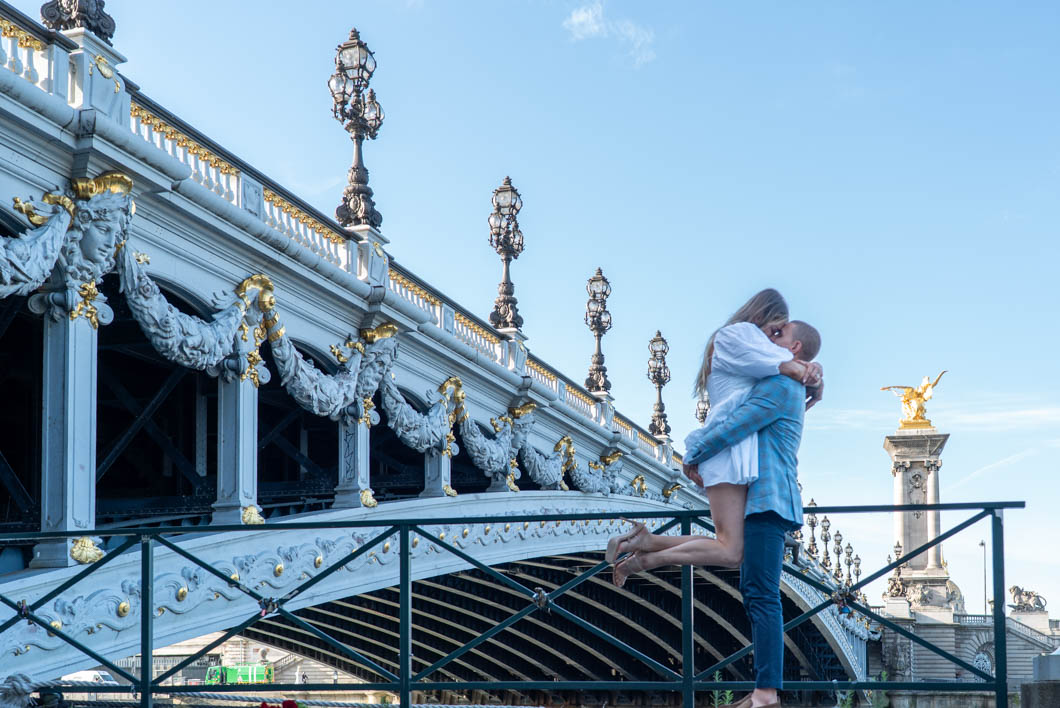 Couple devant les sculptures du pont Alexandre III à Paris